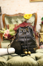 Vintage Chanel Medium Sized Black Caviar Leather Bucket Bag With Golden CC Logo At The Bottom With Original Pouch Inside