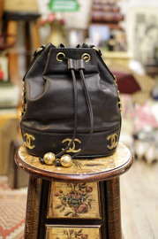 Vintage Chanel Medium Sized Black Caviar Leather Bucket Bag With Golden CC Logo At The Bottom With Original Pouch Inside